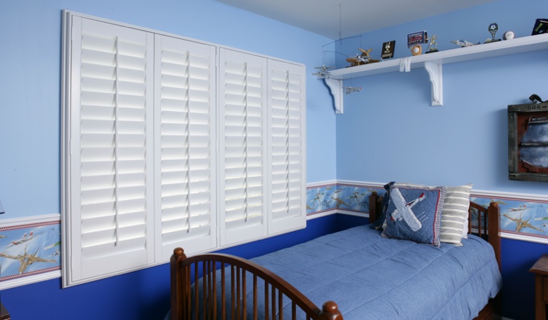 White plantation shutters in blue kids bedroom in Orlando 